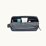 rPET Washbag in blue, open, showing capacity and toiletries