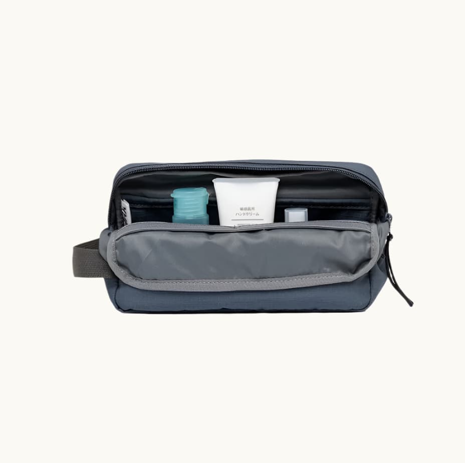 rPET Washbag in blue, open, showing capacity and toiletries