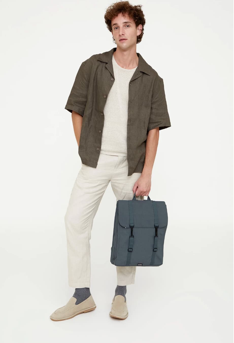 Water Resistant Slim Backpack 12L in laurel, worn, showing logo placement