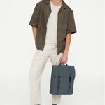 Water Resistant Slim Backpack 12L in laurel, worn, showing logo placement
