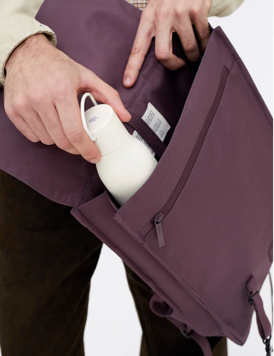 Water Resistant Slim Backpack 12L in maroon, showing the side pocket for a water bottle