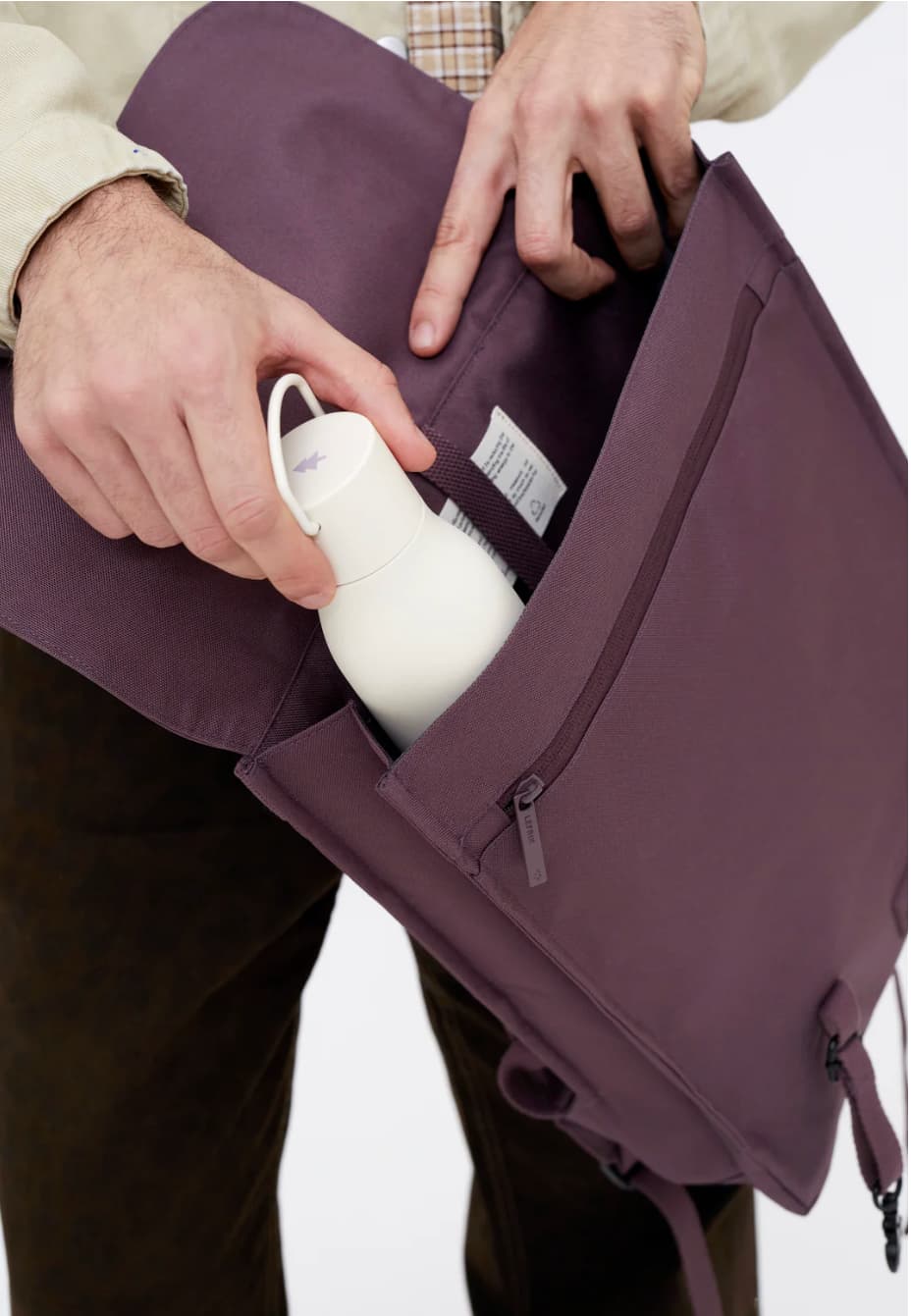 Water Resistant Slim Backpack 12L in maroon, showing the side pocket for a water bottle