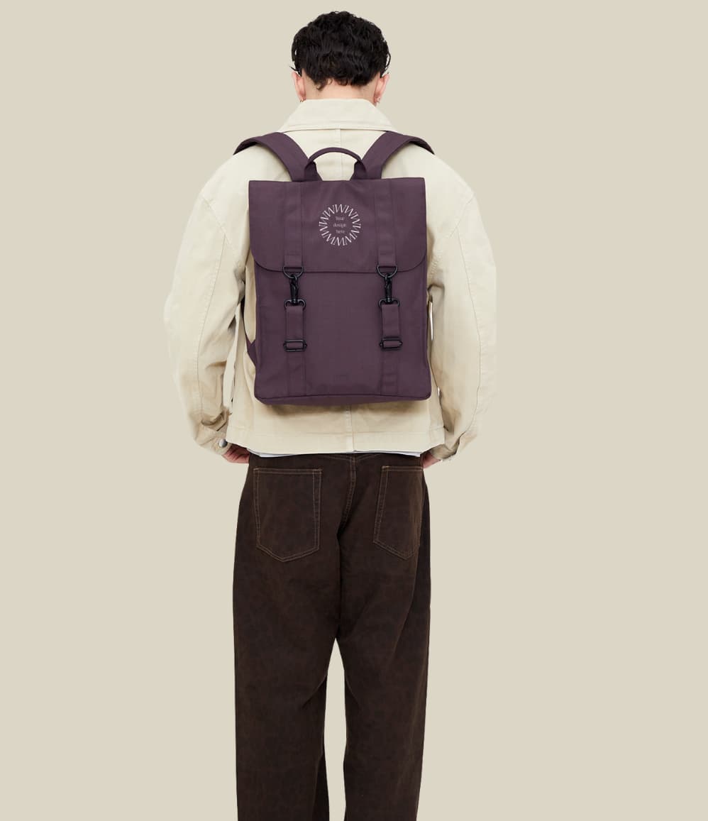 Water Resistant Slim Backpack 12L in maroon, worn on the back, showing logo placement