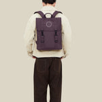 Water Resistant Slim Backpack 12L in maroon, worn on the back, showing logo placement