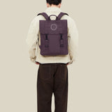 Water Resistant Slim Backpack 12L in maroon, worn on the back, showing logo placement