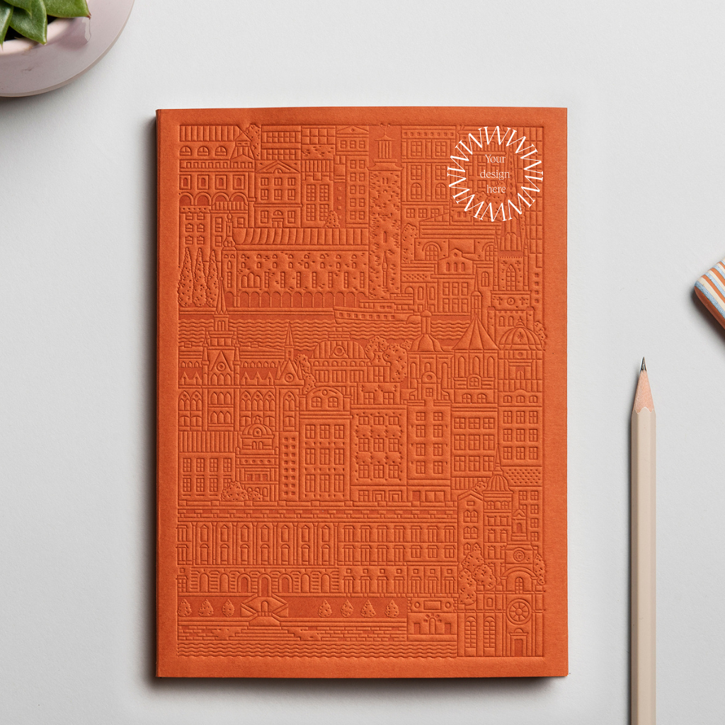 Debossed Stockholm notebook in orange. Sustainable event merchandise from women-owned brands