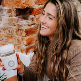 Takeaway Glass Coffee Cup 340ml in light grey, held by a woman, showing logo placement