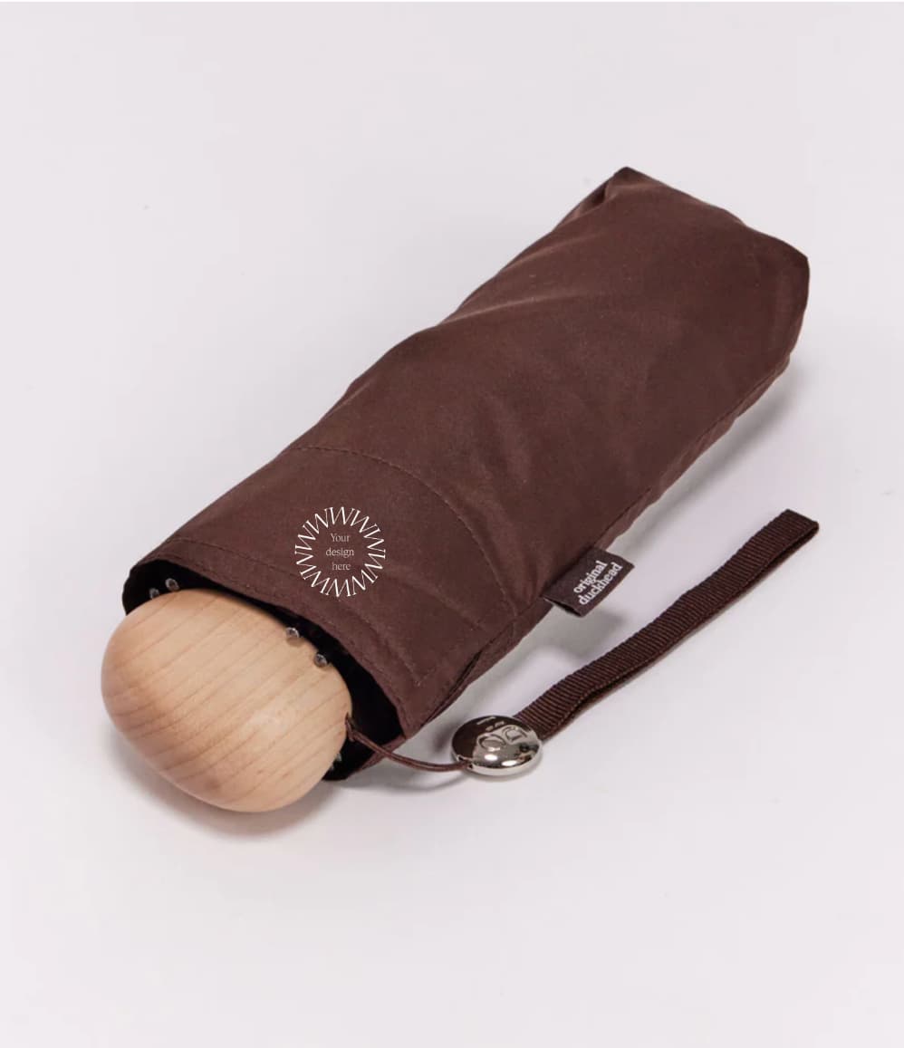 Ultra Compact Mini Umbrella in brown, in its carry bag