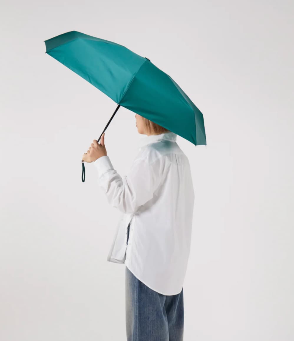 Ultra Compact Mini Umbrella in forest green, held