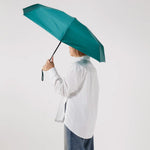 Ultra Compact Mini Umbrella in forest green, held