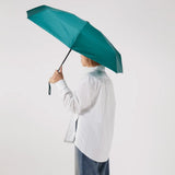 Ultra Compact Mini Umbrella in forest green, held