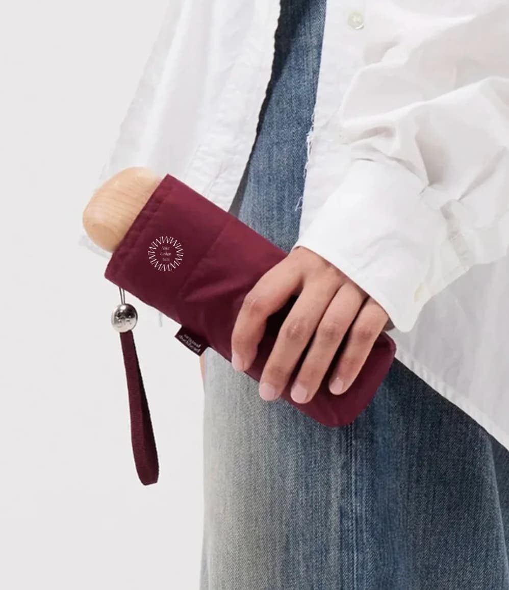 Ultra Compact Mini Umbrella in raspberry, held, closed