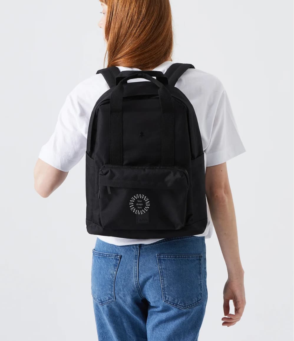Water Resistant Backpack 15L in black, worn on the back by a woman, showing logo placement
