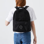 Water Resistant Backpack 15L in black, worn on the back by a woman, showing logo placement