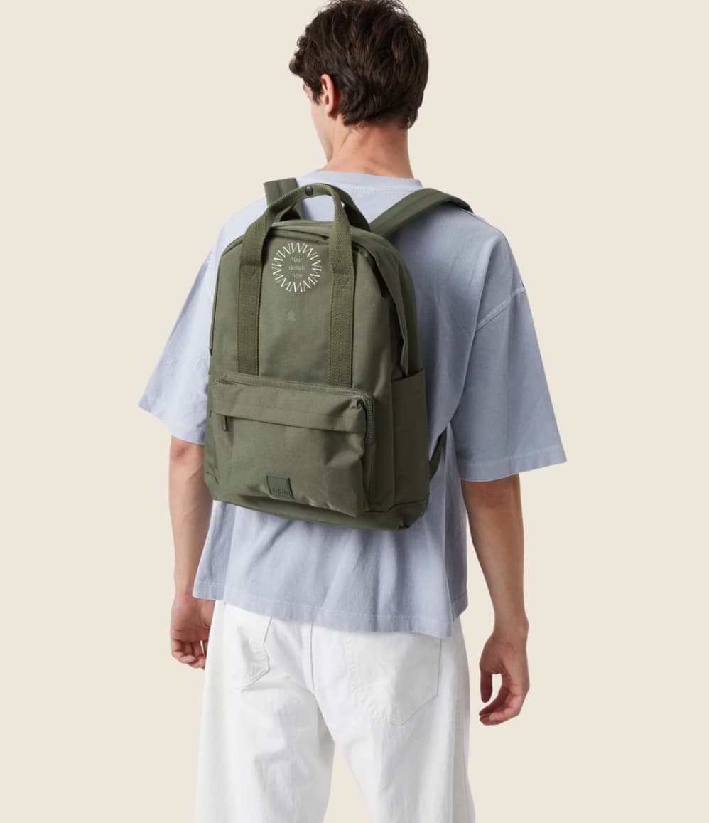 Water Resistant Backpack 15L in green olive, worn on the back by a  man, showing logo placement