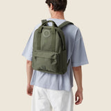 Water Resistant Backpack 15L in green olive, worn on the back by a  man, showing logo placement