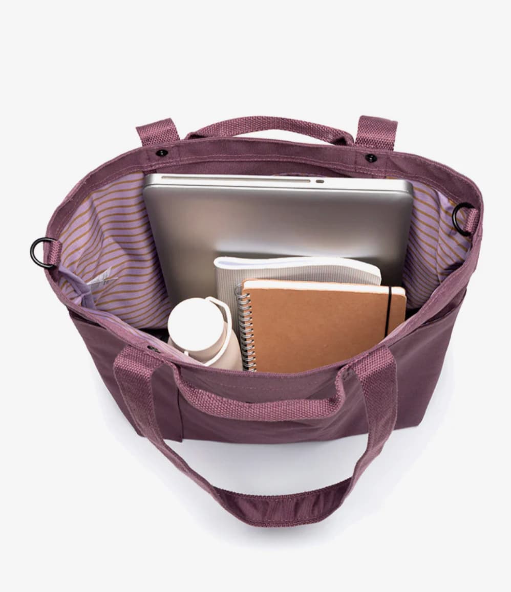 Interior of maroon water-resistant personalised conference bag showing the main compartment and inner pocket.