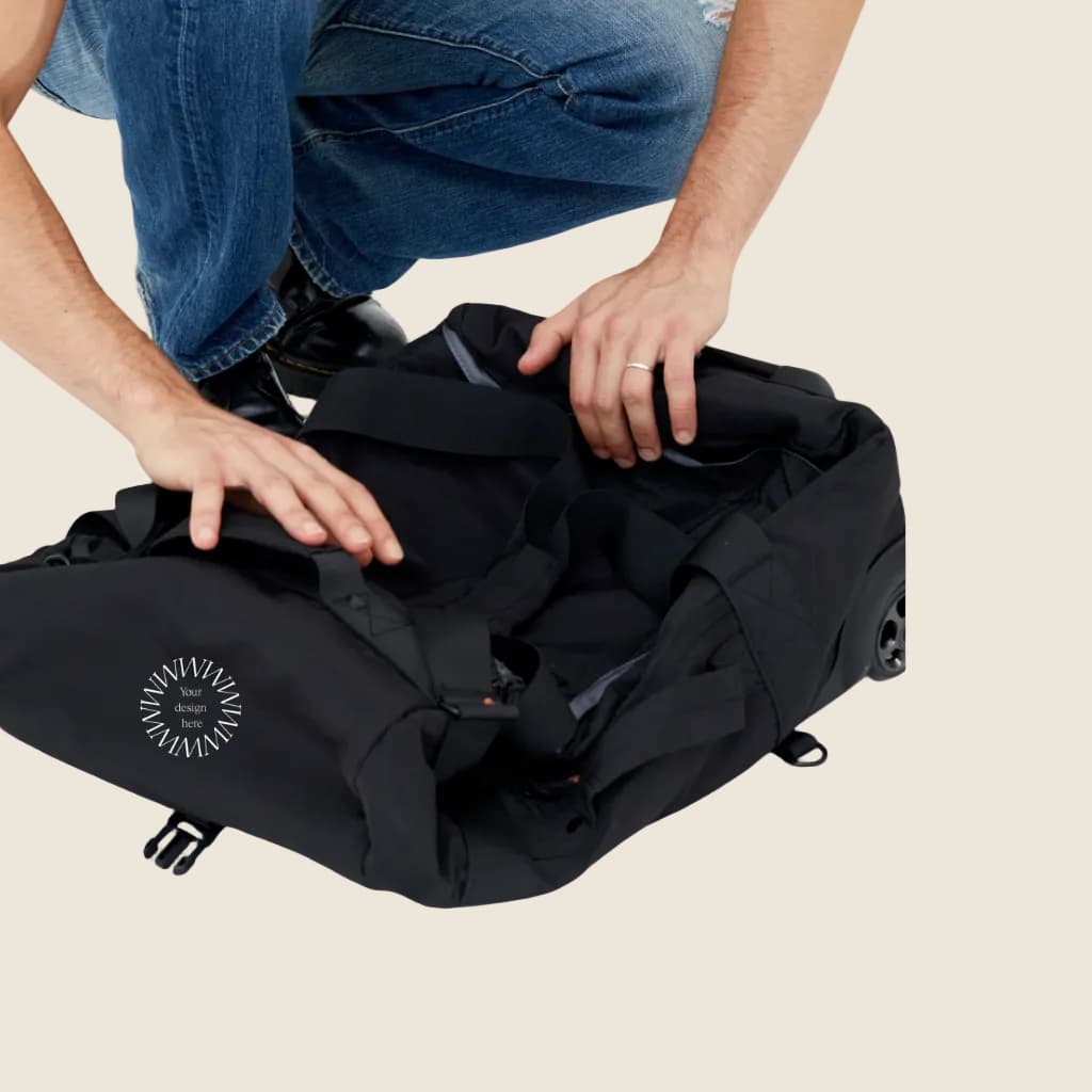 Wheeled Duffel 37L in black, folded and showing logo placement.