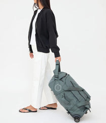 Wheeled Duffel 37L in laurel, being pulled, showing logo placement