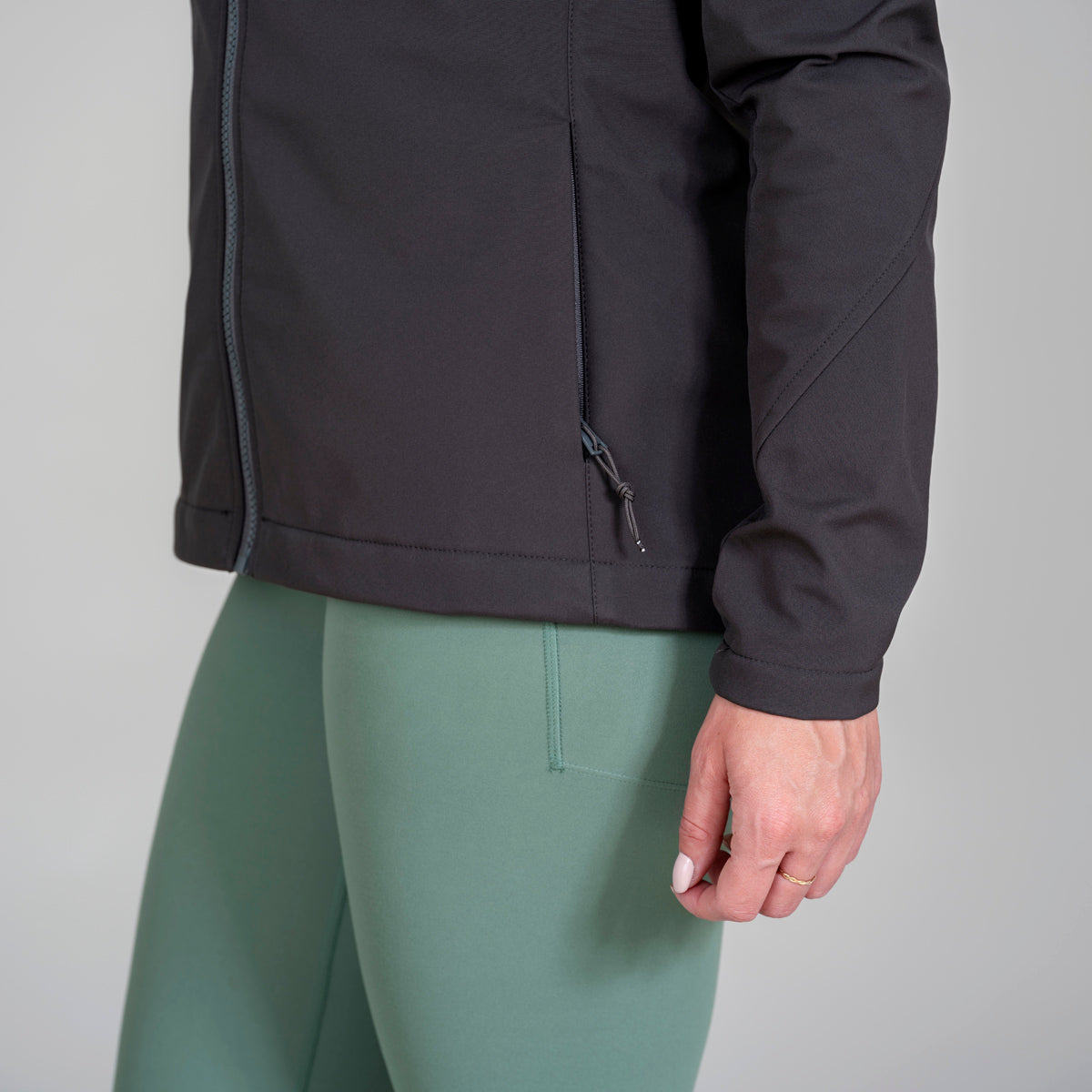 Women’s soft shell hoodie detail view in charcoal. Eco branded company swag for staff appreciation and events.