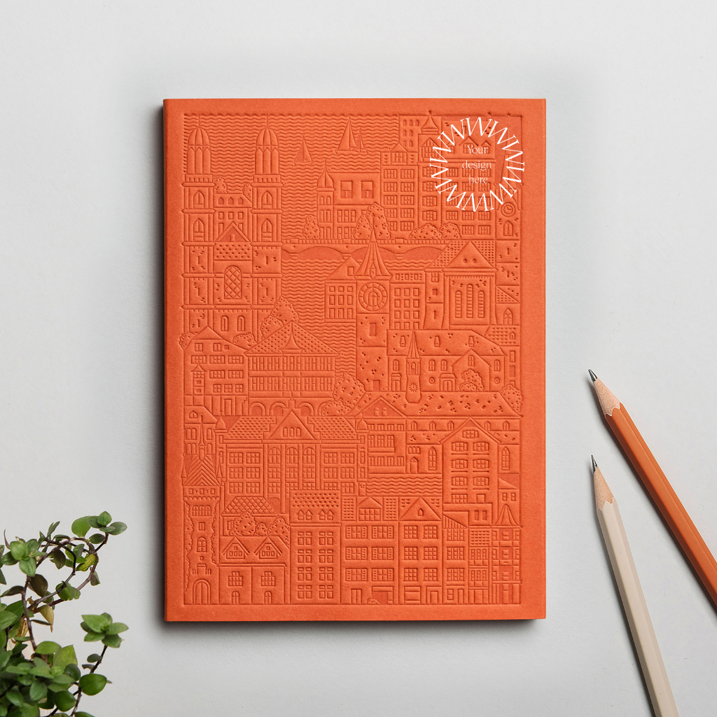 Debossed Zurich notebook in orange. Sustainable event merchandise from women-owned brands.