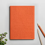 Debossed orange Zurich notebook personalised for corporate events, premium sustainable swag for clients and teams